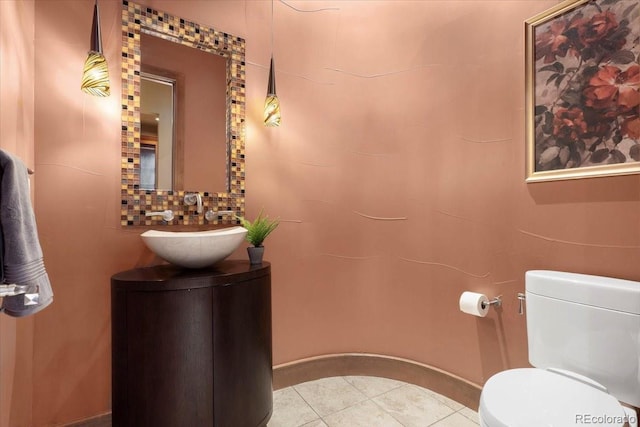 bathroom featuring vanity, tile patterned floors, and toilet