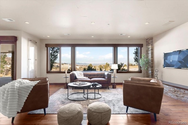 living room with plenty of natural light and hardwood / wood-style floors