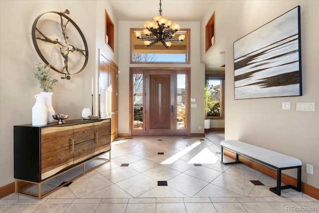 tiled entrance foyer with an inviting chandelier and a towering ceiling