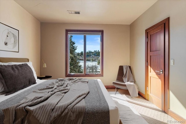 bedroom with visible vents and baseboards