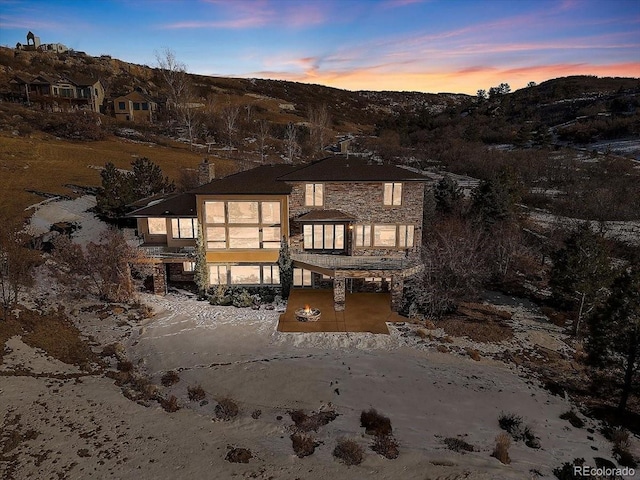 view of front of house with stone siding and a mountain view