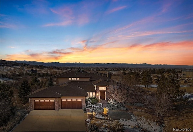 10370 Grande Vista Ct, Lone Tree, CO 80124 - prairie-style house with a mountain view, an attached garage, concrete driveway, and stone siding