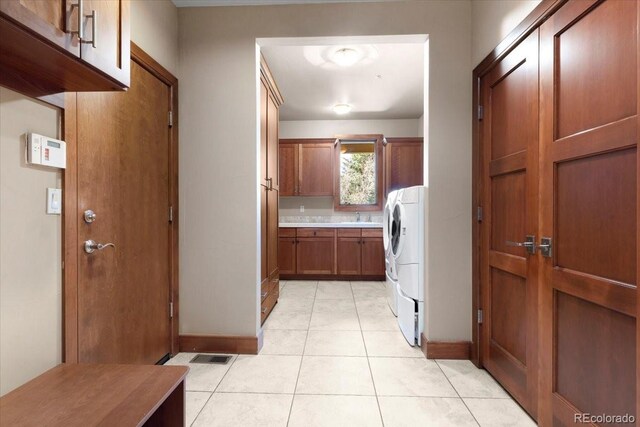 10370 Grande Vista Ct, Lone Tree, CO 80124 - washroom with cabinet space, baseboards, and light tile patterned floors