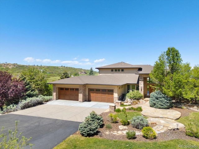 10370 Grande Vista Ct, Lone Tree, CO 80124 - view of front of home with a garage, stone siding, and driveway