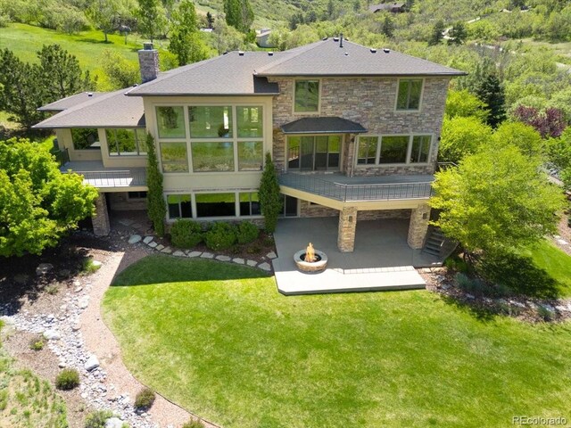 10370 Grande Vista Ct, Lone Tree, CO 80124 - rear view of property with a wooden deck, a patio area, a chimney, and a lawn