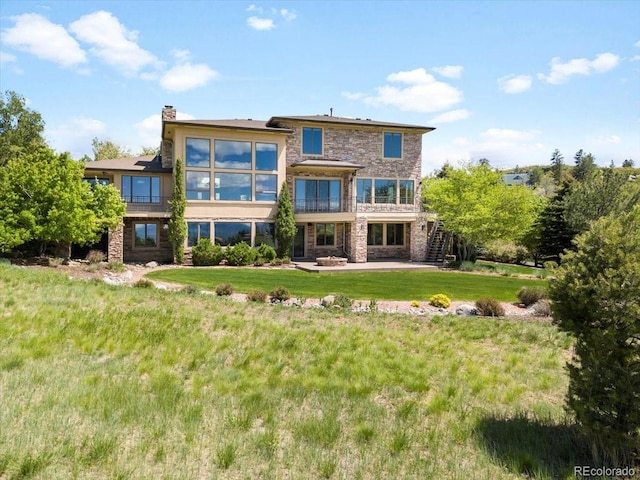 10370 Grande Vista Ct, Lone Tree, CO 80124 - back of property featuring a lawn, stone siding, stairway, a patio area, and a chimney