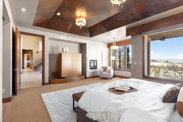 10370 Grande Vista Ct, Lone Tree, CO 80124 - bedroom with a raised ceiling, light colored carpet, baseboards, and access to exterior