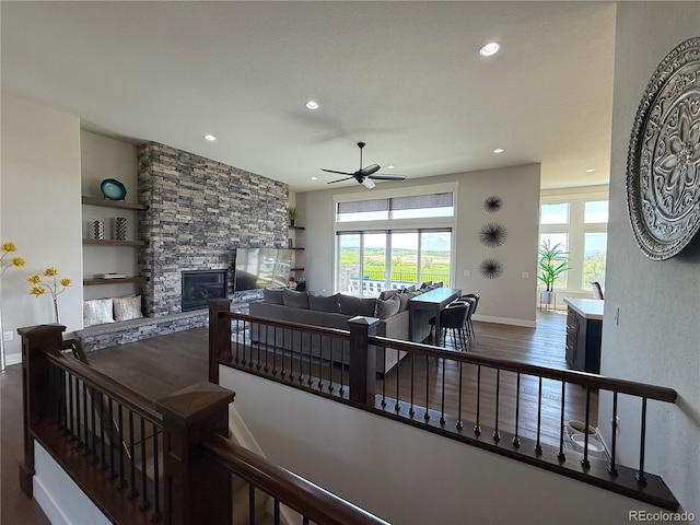 3125 Red Kit Rd, Franktown, CO 80116 - staircase with plenty of natural light, recessed lighting, a ceiling fan, a stone fireplace, and wood finished floors
