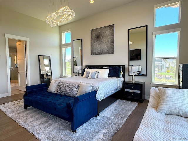 3125 Red Kit Rd, Franktown, CO 80116 - bedroom with a chandelier, a towering ceiling, wood finished floors, and recessed lighting