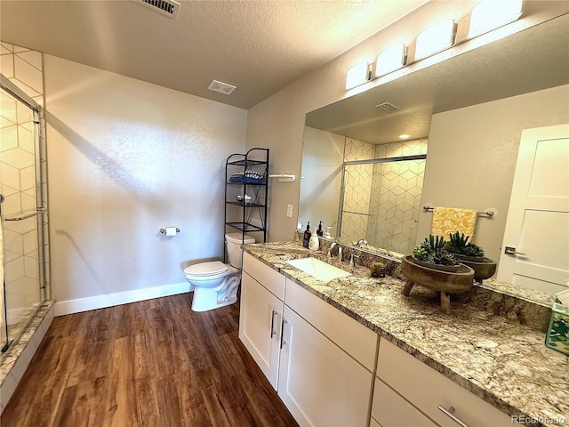 3125 Red Kit Rd, Franktown, CO 80116 - full bath featuring wood finished floors, a stall shower, vanity, and a textured ceiling