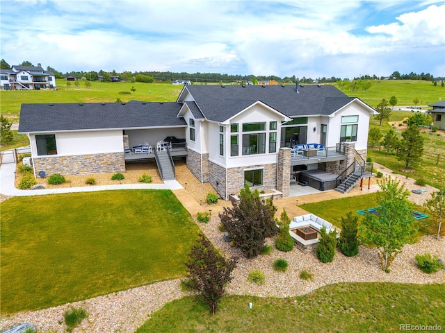 3125 Red Kit Rd, Franktown, CO 80116 - back of house featuring stone siding, stucco siding, a wooden deck, and a fire pit