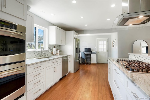 978 Mercury Cir, Lone Tree, CO 80124 - kitchen featuring stainless steel appliances, backsplash, healthy amount of natural light, recessed lighting, and light stone counters