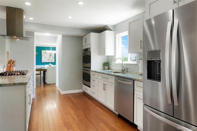 978 Mercury Cir, Lone Tree, CO 80124 - kitchen with stainless steel appliances, island range hood, recessed lighting, light wood finished floors, and light stone countertops