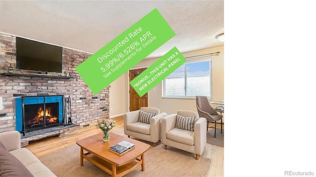 155 S Pennsylvania St Unit 311, Denver, CO 80209 - living room featuring wood finished floors and a brick fireplace