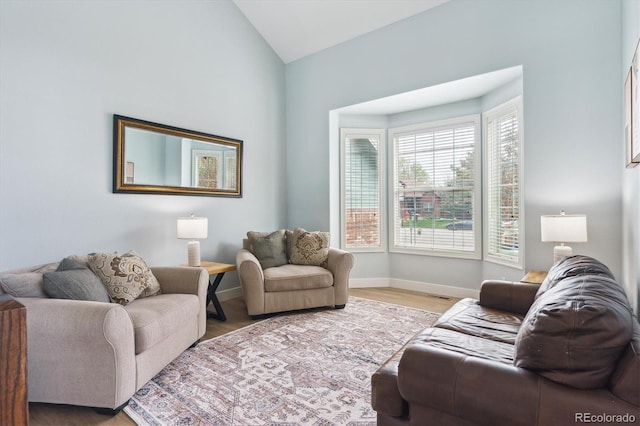 10029 Winterthur Ct, Highlands Ranch, CO 80129 - living room featuring baseboards, light wood-type flooring, and vaulted ceiling