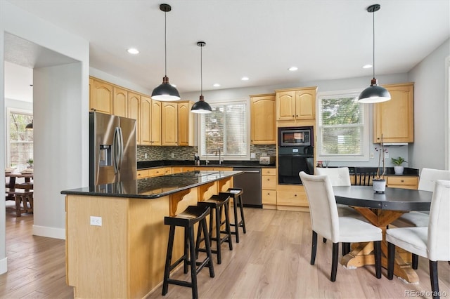 10029 Winterthur Ct, Highlands Ranch, CO 80129 - kitchen with light wood-style flooring, a sink, light brown cabinetry, stainless steel appliances, and backsplash