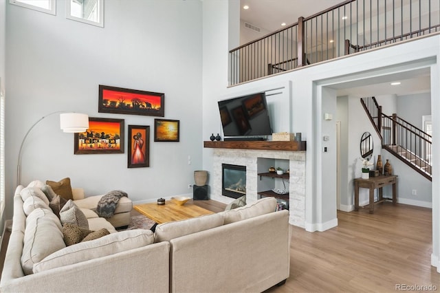 10029 Winterthur Ct, Highlands Ranch, CO 80129 - living area featuring stairway, a fireplace, visible vents, and a high ceiling