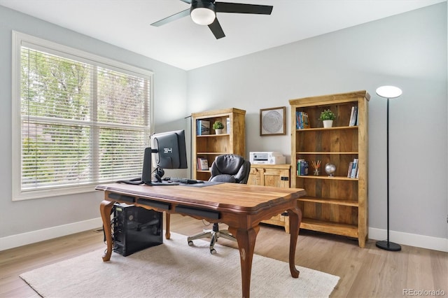 10029 Winterthur Ct, Highlands Ranch, CO 80129 - office area with baseboards, light wood-style floors, a ceiling fan, and plenty of natural light