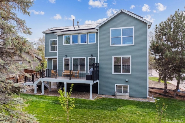 10029 Winterthur Ct, Highlands Ranch, CO 80129 - back of property featuring stairway, solar panels, a lawn, and a deck