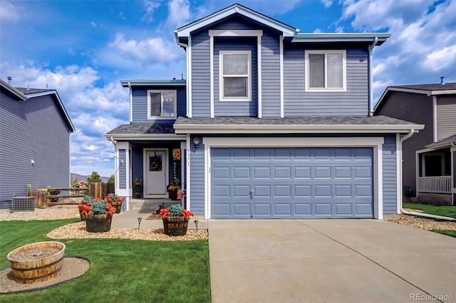 view of property featuring a garage and a front lawn