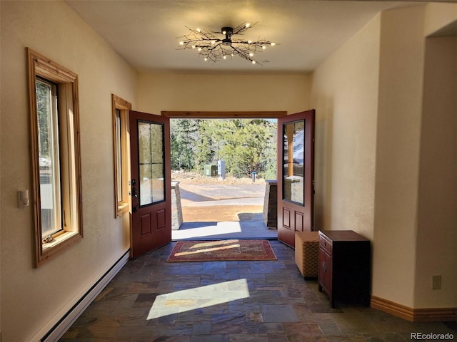 14564 Reserve Rd, Pine, CO 80470 - entrance foyer with stone tile floors, baseboard heating, baseboards, and a chandelier