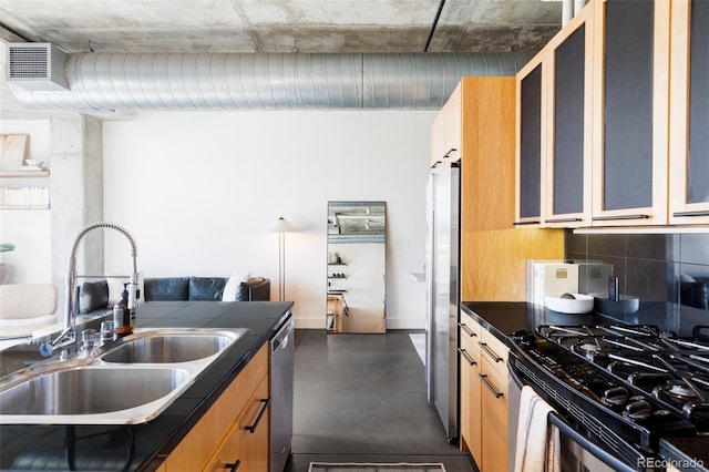 kitchen with decorative backsplash, finished concrete flooring, dark countertops, a sink, and stainless steel appliances