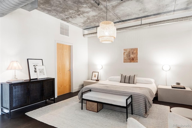 bedroom featuring visible vents and wood finished floors