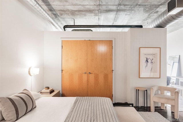 bedroom with a closet and visible vents