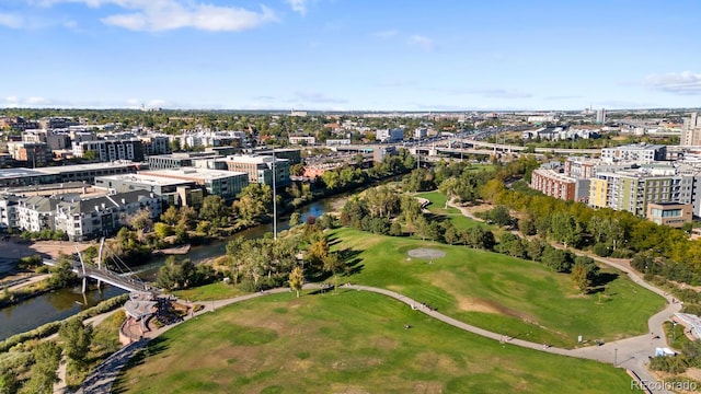 drone / aerial view with a water view and golf course view