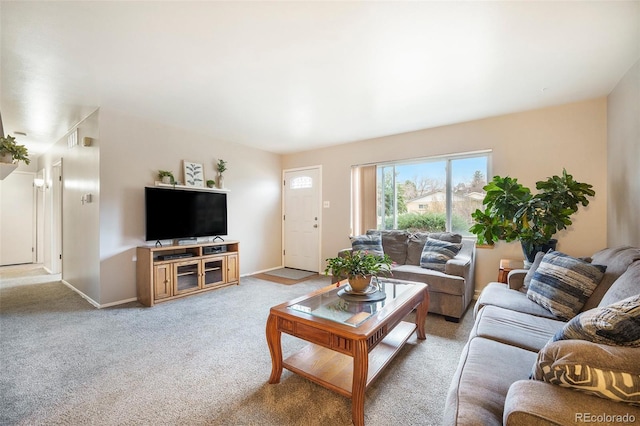 living area featuring baseboards and light carpet