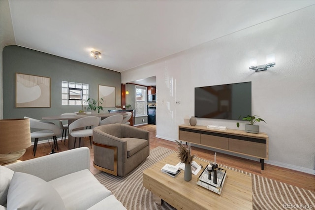 living room featuring baseboards and wood finished floors