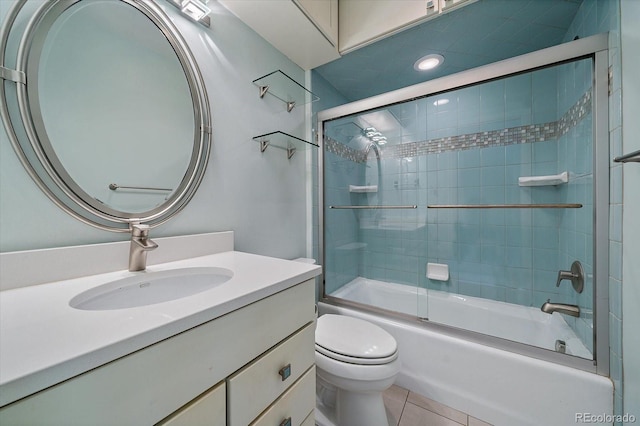 bathroom with toilet, vanity, enclosed tub / shower combo, and tile patterned flooring