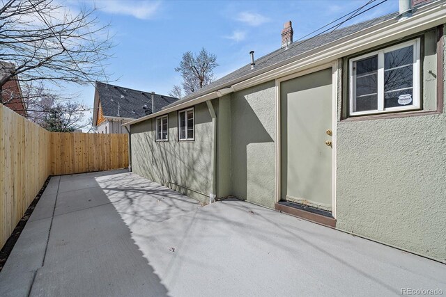 view of patio featuring fence