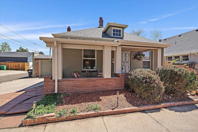 3420 Julian St, Denver, CO 80211 - bungalow-style home featuring covered porch, a chimney, roof with shingles, a garage, and concrete driveway