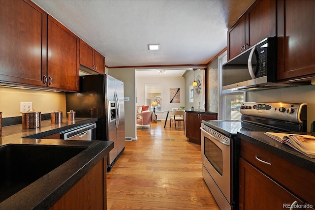 3420 Julian St, Denver, CO 80211 - kitchen featuring dark countertops, appliances with stainless steel finishes, a sink, and light wood-style floors