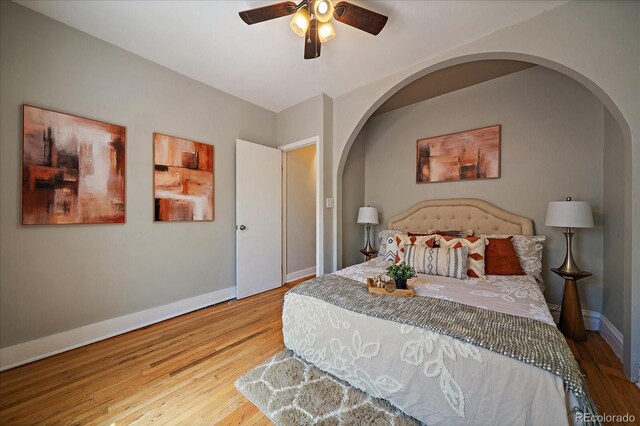 3420 Julian St, Denver, CO 80211 - bedroom with baseboards, arched walkways, a ceiling fan, and wood finished floors
