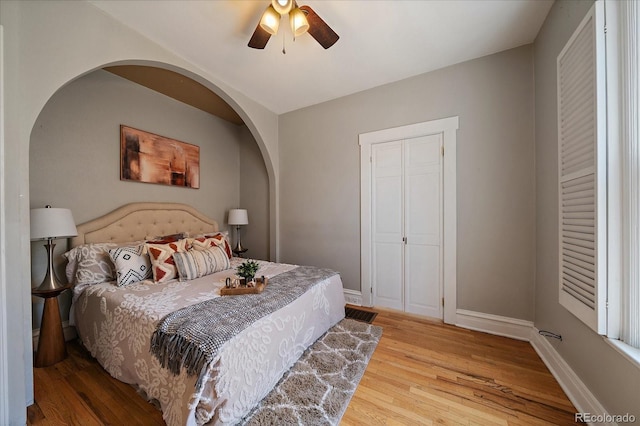 3420 Julian St, Denver, CO 80211 - bedroom featuring baseboards, ceiling fan, arched walkways, and wood finished floors