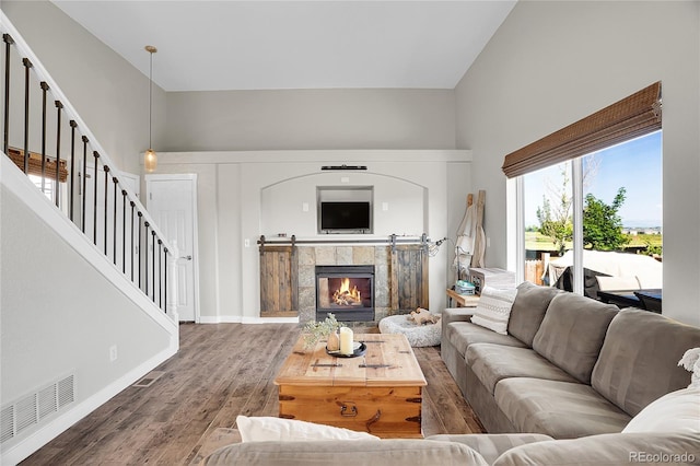 10521 Taylor Ave, Firestone, CO 80504 - living room featuring wood finished floors, stairs, and a towering ceiling