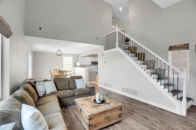 10521 Taylor Ave, Firestone, CO 80504 - living area with a high ceiling, stairway, and wood finished floors