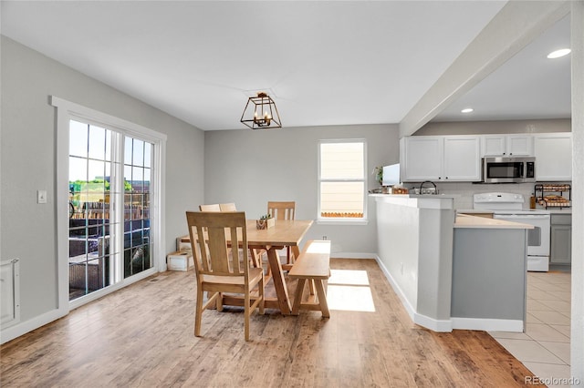 10521 Taylor Ave, Firestone, CO 80504 - dining space featuring plenty of natural light, light wood-style floors, a chandelier, and recessed lighting