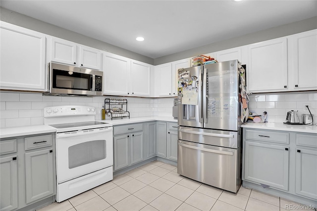10521 Taylor Ave, Firestone, CO 80504 - kitchen featuring appliances with stainless steel finishes, tasteful backsplash, light countertops, gray cabinets, and recessed lighting