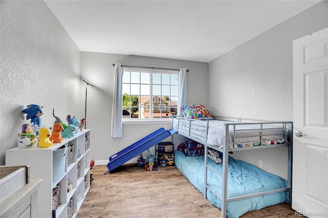 10521 Taylor Ave, Firestone, CO 80504 - bedroom with wood finished floors and a textured wall