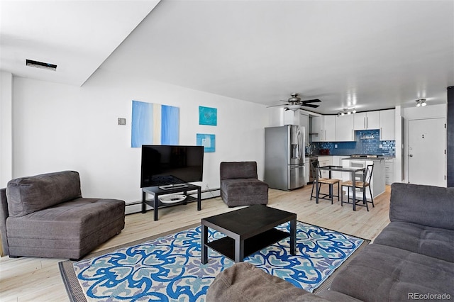 1121 Albion St Unit 210, Denver, CO 80220 - living area featuring light wood-type flooring, a ceiling fan, and a baseboard radiator