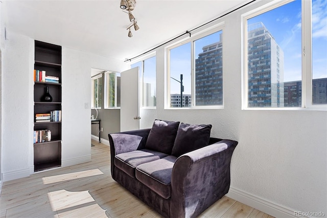 1121 Albion St Unit 210, Denver, CO 80220 - sitting room with baseboards, wood finished floors, and a city view