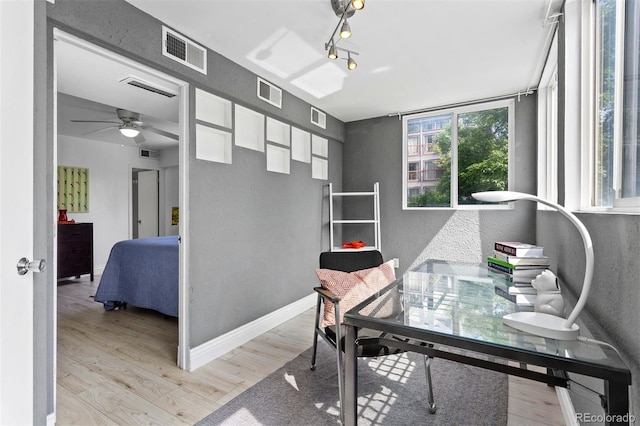 1121 Albion St Unit 210, Denver, CO 80220 - home office with ceiling fan, light wood finished floors, and a textured wall