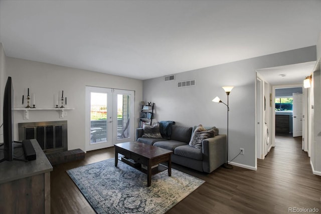 519 Wright St Unit 108, Lakewood, CO 80228 - living room featuring dark wood-style floors, a brick fireplace, and baseboards