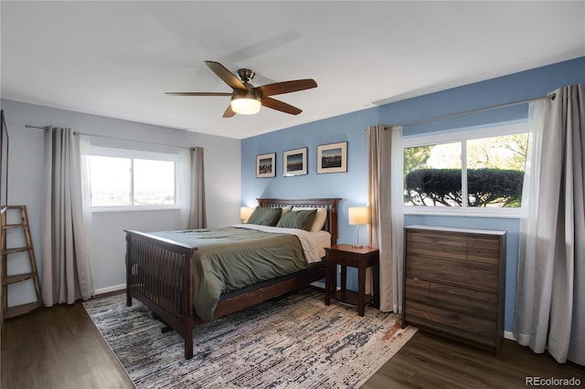 519 Wright St Unit 108, Lakewood, CO 80228 - bedroom with wood finished floors, multiple windows, baseboards, and a ceiling fan
