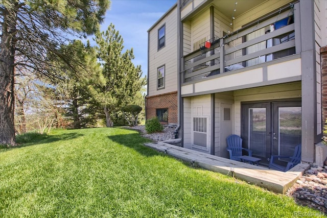 519 Wright St Unit 108, Lakewood, CO 80228 - view of grassy yard featuring a balcony and french doors