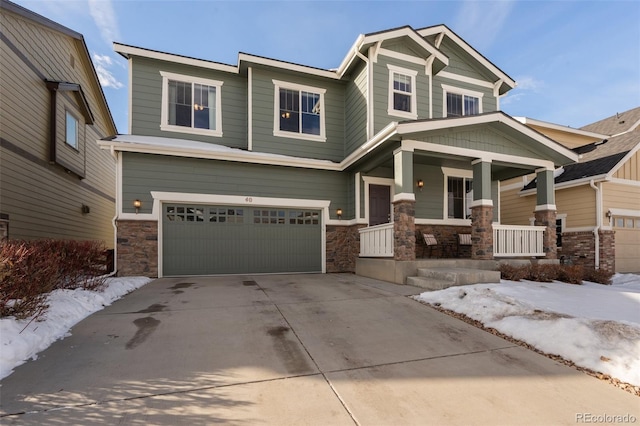 craftsman inspired home with a garage and covered porch