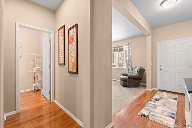 corridor with light hardwood / wood-style floors